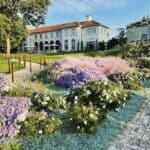 Commodore Perry Estate exterior with flowers in bloom